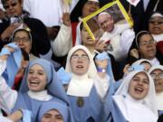 Nuns sing before the arrival of Pope Francis at Venustiano Carranza stadium in Morelia, Mexico, on Tuesday. Francis arrived in the heart of Mexico&#039;s drug-trafficking country to offer words of encouragement to priests trying to minister to a people tormented by the violence and gang warfare of the drug trade.