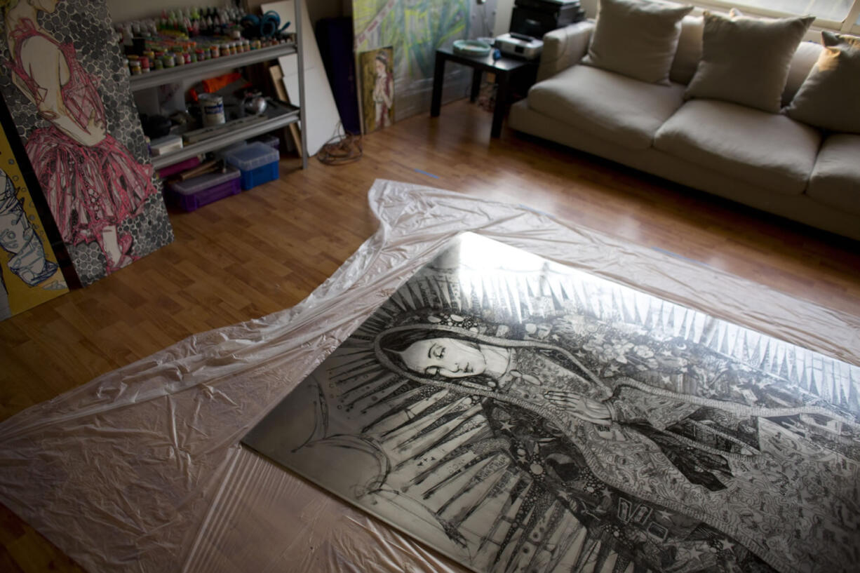 &quot;The Virgin of Immigrants,&quot; an image of the Virgin of Guadalupe ornamented with symbols and phrases related to immigration, is displayed in the studio of artist Eva Vale. She created the aluminum piece for Pope Francis&#039; visit to Mexico.