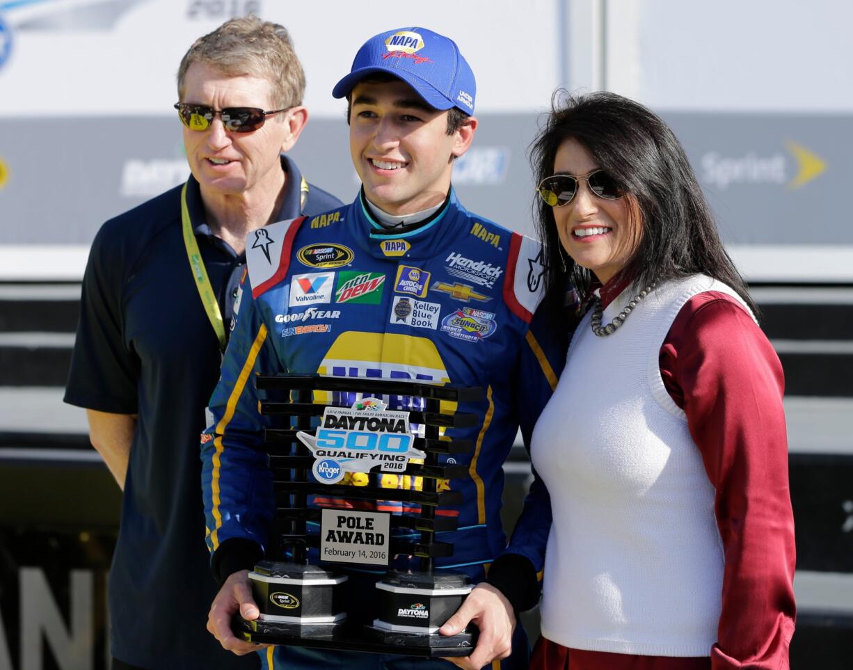 Chase Elliott, center, poses with his parents, former NASCAR driver Bill Elliott, left, and Cindy Elliott, after he qualified for the pole position in the Daytona 500 auto race at Daytona International Speedway, Sunday, Feb. 14, 2016, in Daytona Beach, Fla.