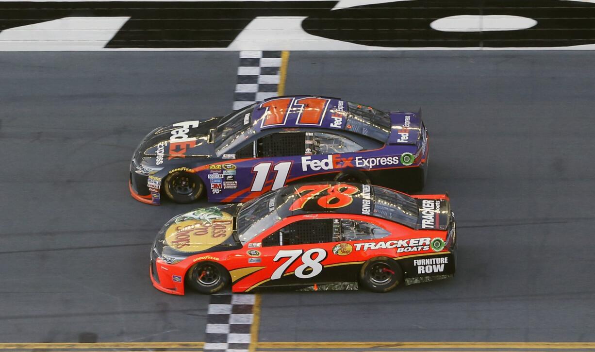 Denny Hamlin (11) beats out Martin Truex Jr. (78) at the finish line to win the NASCAR Daytona 500 auto race at Daytona International Speedway, Sunday, Feb. 21, 2016, in Daytona Beach, Fla.