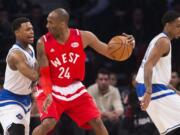 Western Conference's Kobe Bryant, of the Los Angeles Lakers (24) tries to move the ball past Eastern Conference's Kyle Lowry, of the Toronto Raptors, left, during the first half of the NBA all-star basketball game, Sunday, Feb. 14, 2016 in Toronto.