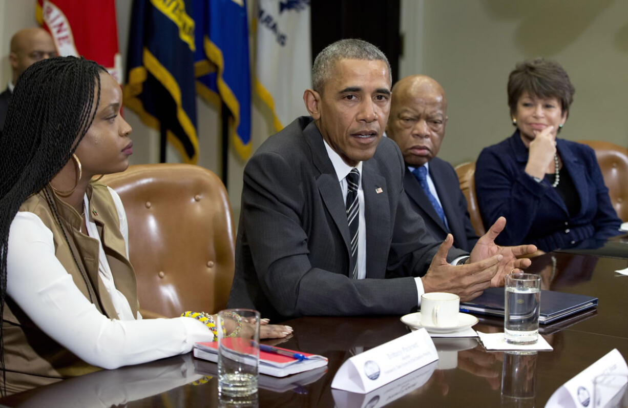 President Barack Obama speaks to the media at a meeting with civil rights leaders Thursday at the White House in Washington. From left are, Brittany Packnett, the president, Rep, John Lewis, D-Ga., and Senior White House Adviser Valerie Jarrett.