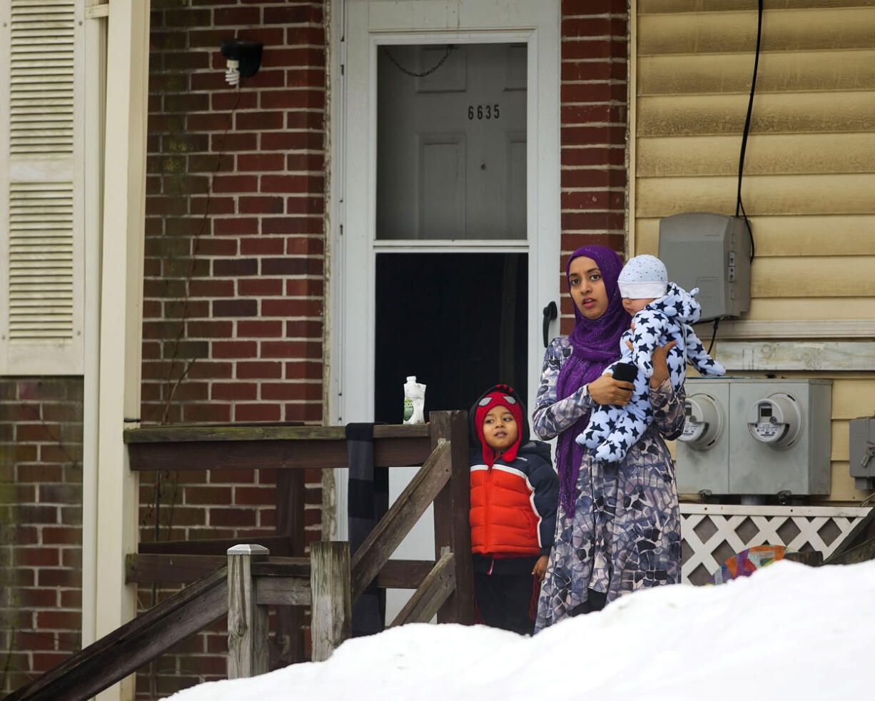 A woman with her children watches President Barack Obama&#039;s motorcade arrive at the Islamic Society of Baltimore on Wednesday in Baltimore, Md. Obama is making his first visit to a U.S.