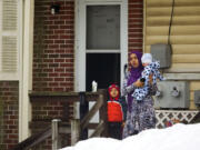 A woman with her children watches President Barack Obama&#039;s motorcade arrive at the Islamic Society of Baltimore on Wednesday in Baltimore, Md. Obama is making his first visit to a U.S.