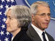 Dr. Anthony Fauci, director of NIH/NIAID, right, and Dr. Anne Schuchat, principal deputy director of the CDC, participate in a press briefing Monday at the White House in Washington.