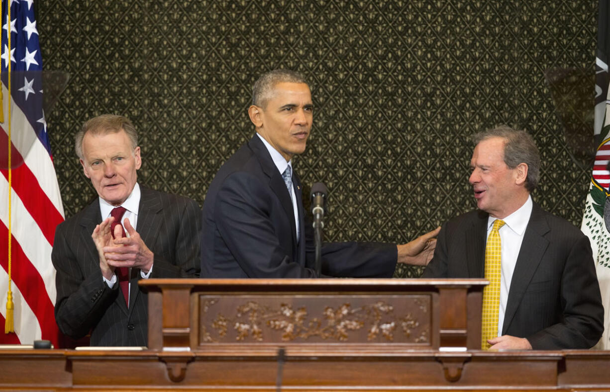 President Barack Obama is greeted by Illinois Senate President John Cullerton, right, and Illinois House Speaker Michael Madigan before addressing the Illinois General Assembly on Wednesday at the Illinois State Capitol in Springfield, Ill. Obama returned to Springfield, the place where his presidential career began, to mark the ninth anniversary of his entrance in the 2008 presidential race.