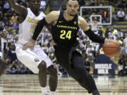 Oregon's Dillon Brooks, right, drives the ball against California's Jabari Bird in the first half of an NCAA college basketball game Thursday, Feb. 11, 2016, in Berkeley, Calif.