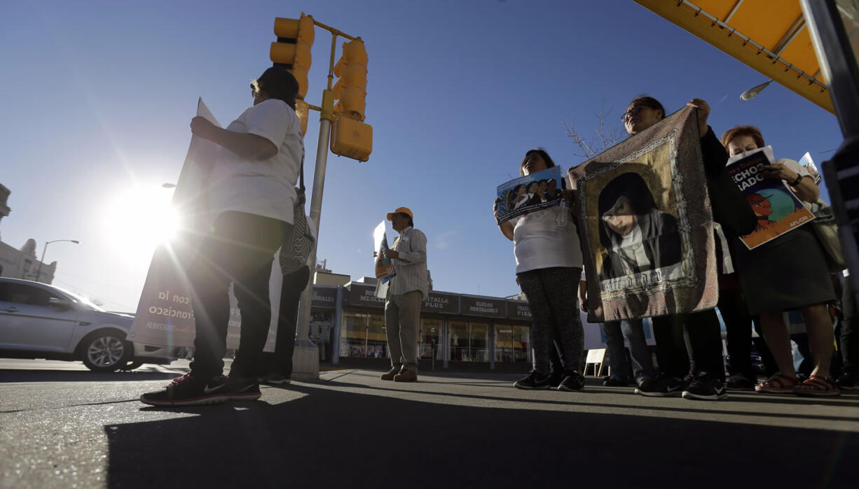 Women and labor leaders from El Paso and around the country march through downtown El Paso, Texas, on Tuesday. Pope Francis is holding a mass in Mexico in neighboring Ciudad Juarez on Wednesday.