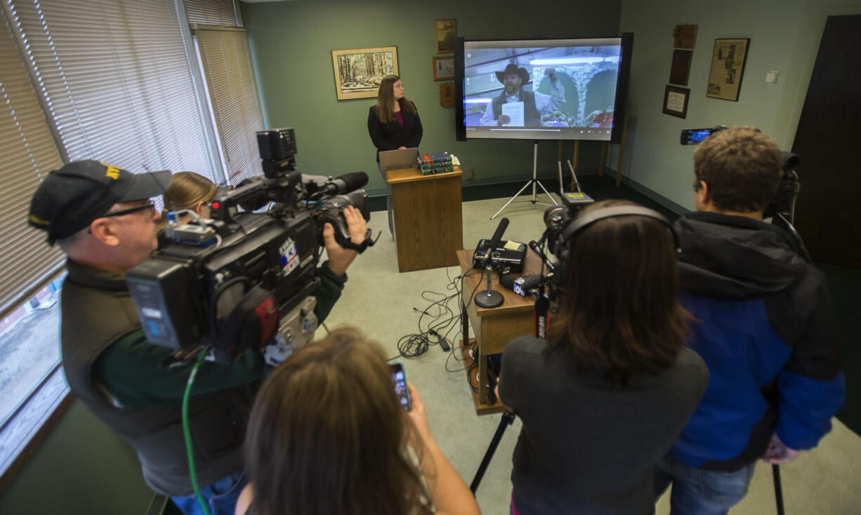 Lissa Casey, attorney for Ammon Bundy, listens to a recorded statement by Bundy on Thursday in Eugene, Ore.. The statement was recorded during a telephone conversation between Bundy and his attorneys, Arnold and Lissa Casey, from the Multnomah County Jail. Authorities arrested Bundy, the leader of an armed group occupying Malheur National Wildlife Refuge, and others on a remote road when they left the Oregon refuge for a community meeting.