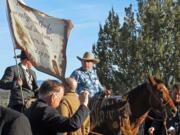 Cliven Bundy, on horseback at center, joins the funeral procession for Arizona rancher Robert "LaVoy" Finicum in Kanab, Utah, on  Feb. 5. Hundreds of people packed a Mormon church in rural Utah for the viewing ceremony for the fallen spokesman of the Oregon armed standoff. Police shot and killed Finicum during a Jan. 26 traffic stop after they say he reached for a gun.