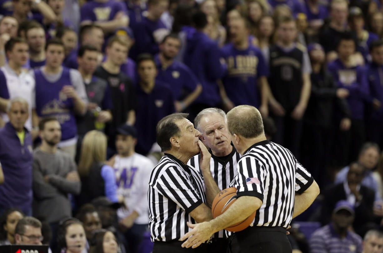 FILE - In this Wednesday Feb. 3, 2016, file photo, officials discuss a call between Washington and Arizona State during the second half of an NCAA college basketball game in Seattle. Referees undergo nearly as much scrutiny as the teams that want to join in March Madness, with a field of nearly 1,000 that is winnowed to 100 for tournament time. And just like the teams, the refs have to be on their game to keep advancing.