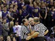 FILE - In this Wednesday Feb. 3, 2016, file photo, officials discuss a call between Washington and Arizona State during the second half of an NCAA college basketball game in Seattle. Referees undergo nearly as much scrutiny as the teams that want to join in March Madness, with a field of nearly 1,000 that is winnowed to 100 for tournament time. And just like the teams, the refs have to be on their game to keep advancing.