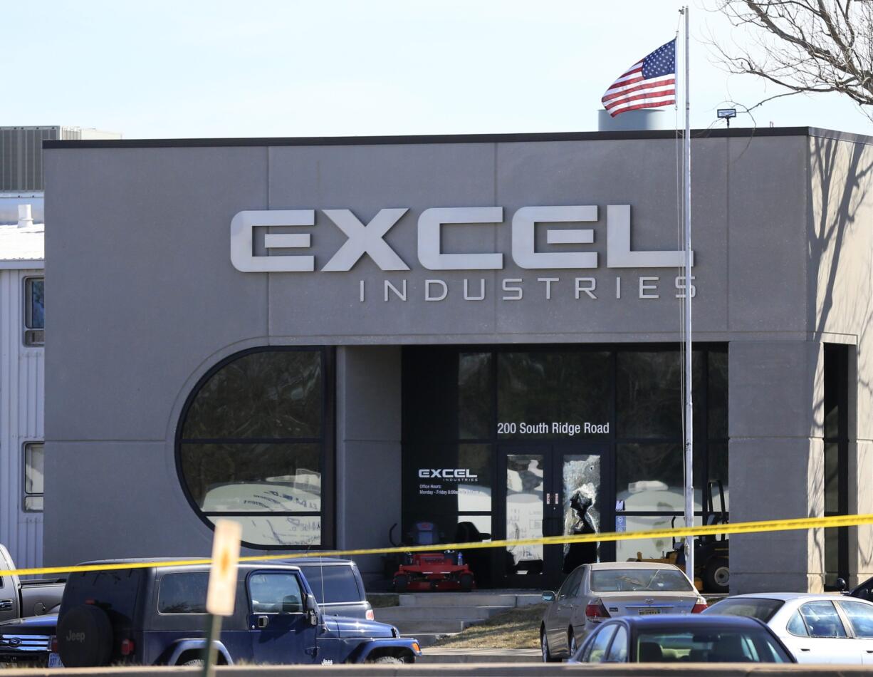 Shattered glass and bullet holes are seen at the front door of Excel Industries in Hesston, Kan., Friday, Feb. 26, 2016. Harvey County Sheriff T. Walton identified the gunman as Cedric Ford, who stormed into the factory where he worked and shot several people.