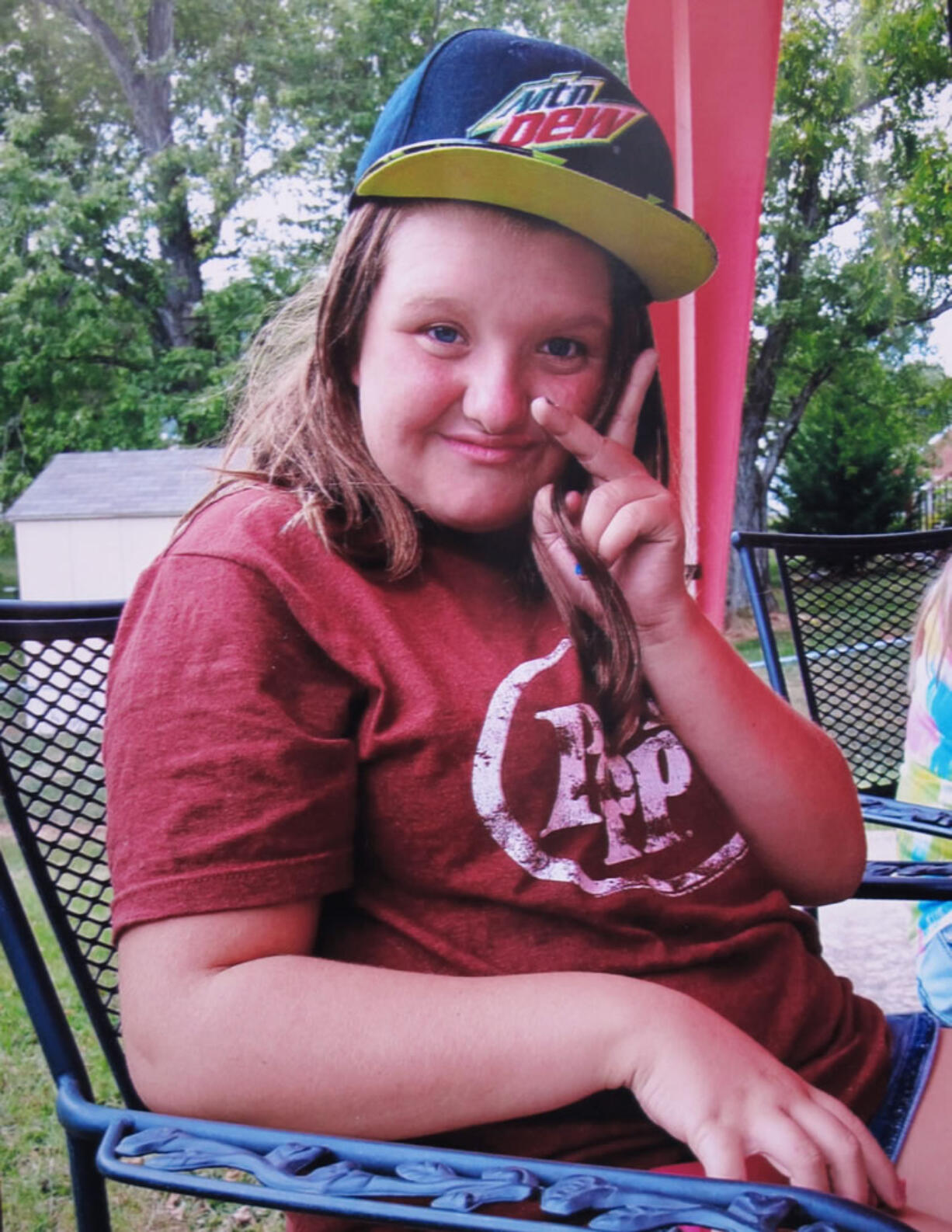 Nicole Lovell, 13, flashes a peace sign in this family photo.