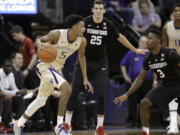 Washington guard Dejounte Murray (5) drives against Stanford's Malcolm Allen, right, and Rosco Allen, center, during the first half of an NCAA college basketball game Saturday, Feb. 20, 2016, in Seattle. (AP Photo/Ted S.