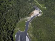 The Elwha River flows through what was Lake Aldwell and freely past the old Elwha Dam, at the bend at right, near Port Angeles in June 2014. Scientists are working to develop templates for habitat restoration to bolster struggling salmon and steelhead populations.