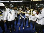 Miss Universe Pia Alonzo Wurtzbach dances with Carolina Panthers players during Opening Night for the NFL Super Bowl 50 football game Monday, Feb. 1, 2016, in San Jose, Calif.