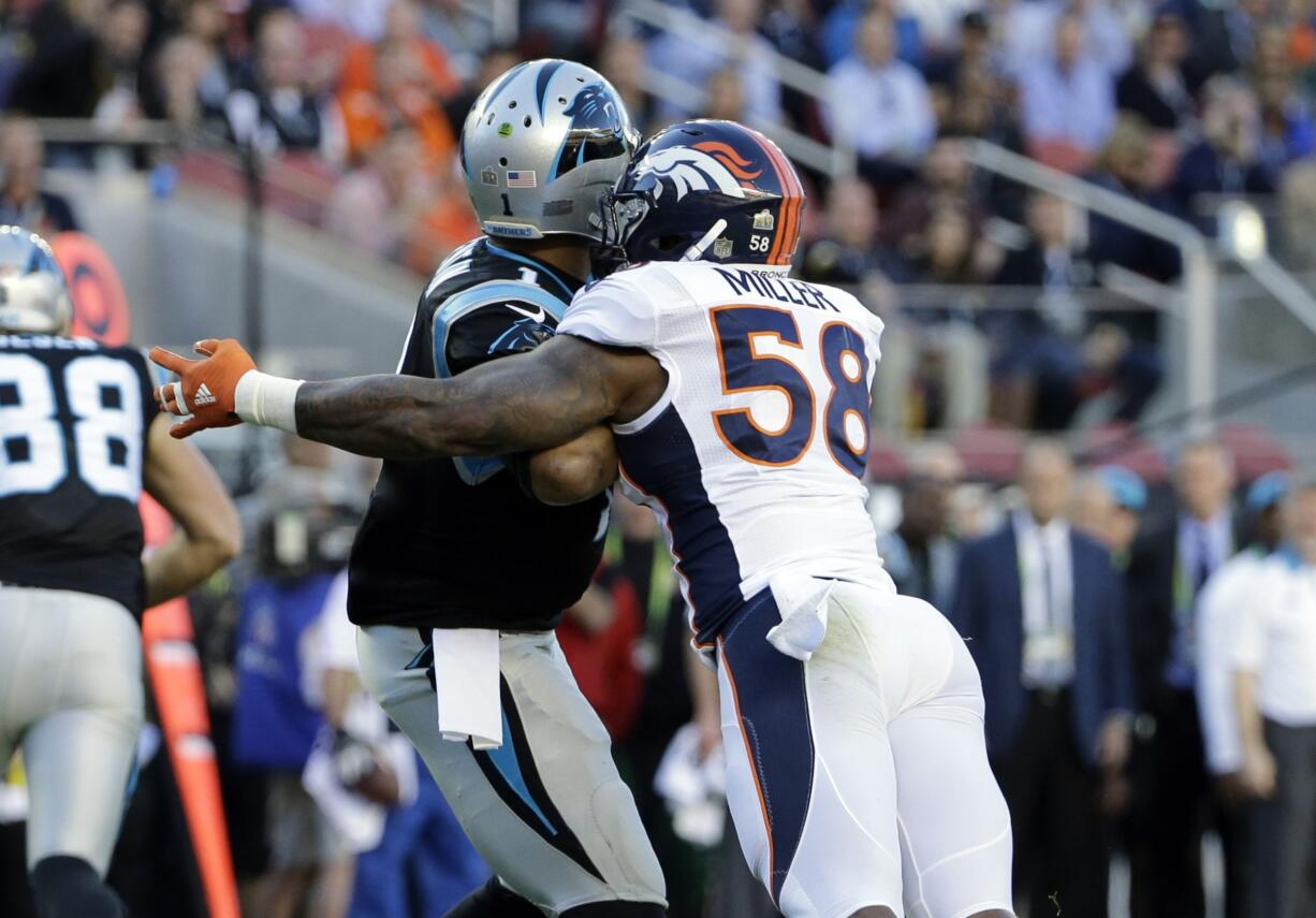 Denver Broncos’ Von Miller (58) hits Carolina Panthers’ Cam Newton, left, causing a fumble that was recovered for a touchdown during the first half of the NFL Super Bowl 50 football game Sunday, Feb. 7, 2016, in Santa Clara, Calif.