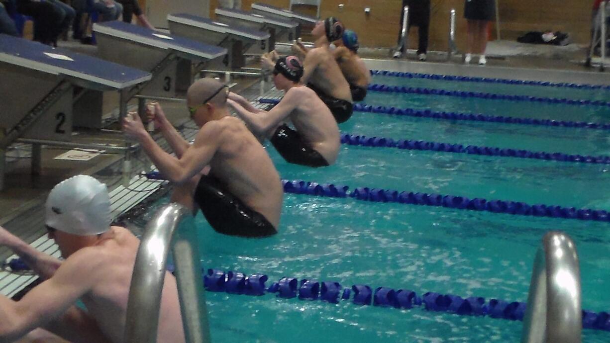 Competitors get ready to swim the 100 backstroke at the 4A district meet Saturday in Kelso (Tim Martinez/The Columbian)