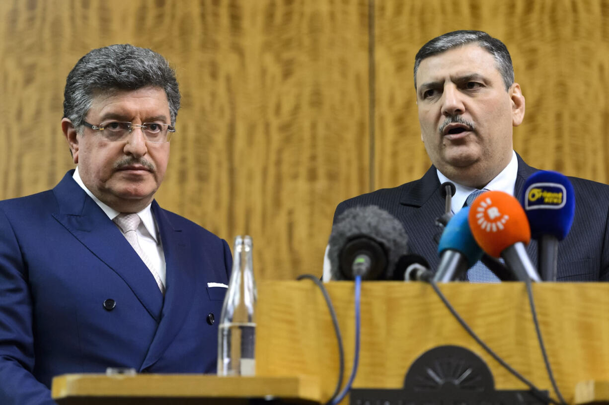 Syrian opposition chief Riad Hijab, right, and High Negotiations Committee spokesman Salem al-Meslet, attend a press conference Wednesday after Syrian peace talks at the President Wilson hotel in Geneva, Switzerland.