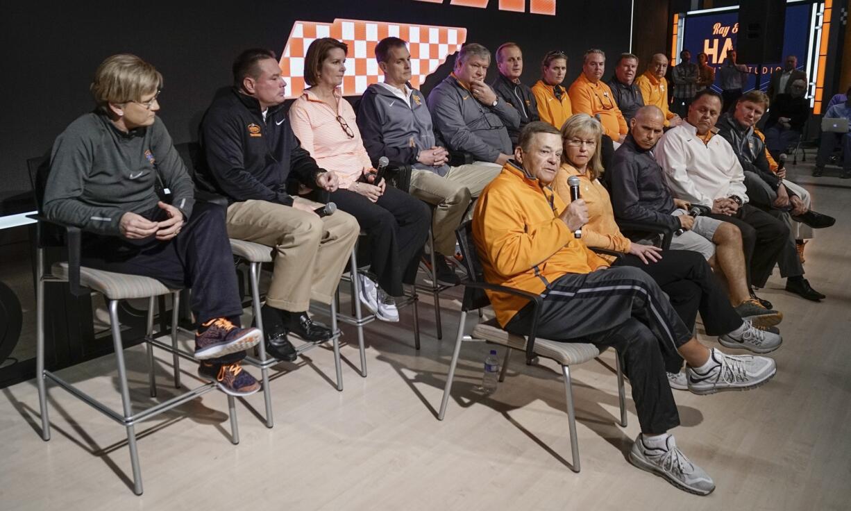 Tennessee softball coach Ralph Weekly, front row left, speaks during a news conference Tuesday in Knoxville, Tenn. The school&#039;s coaches held a news conference two weeks after a group of unidentified women sued the school over its handling of sexual assault complaints made against student-athletes. Seated to the right of Weekly is his wife and co-coach, Karen Weekly.