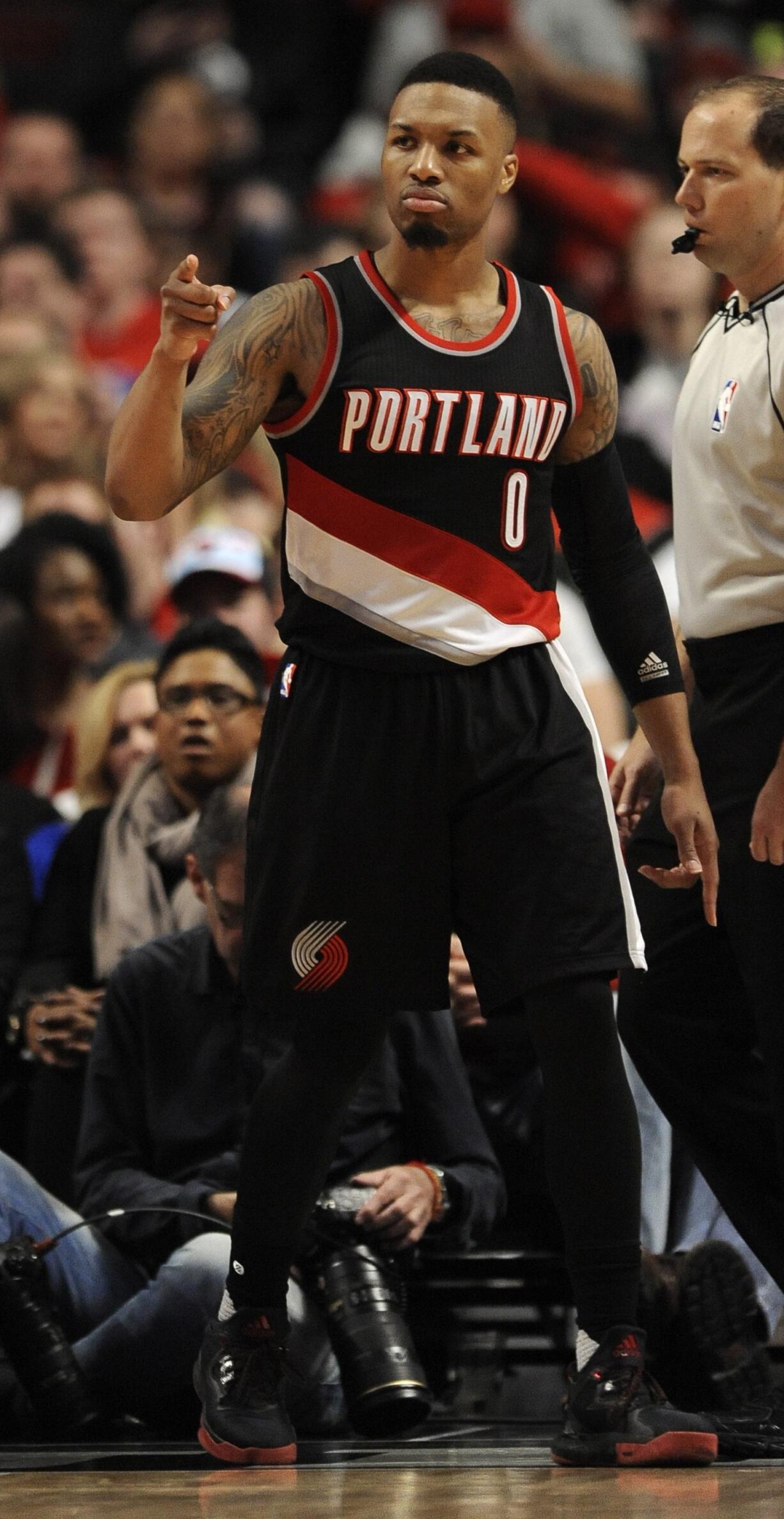 Portland Trail Blazers&#039; Damian Lillard (0), celebrates after making a basket during the second half of an NBA basketball game against the Chicago Bulls, Saturday, Feb. 27, 2016, in Chicago.