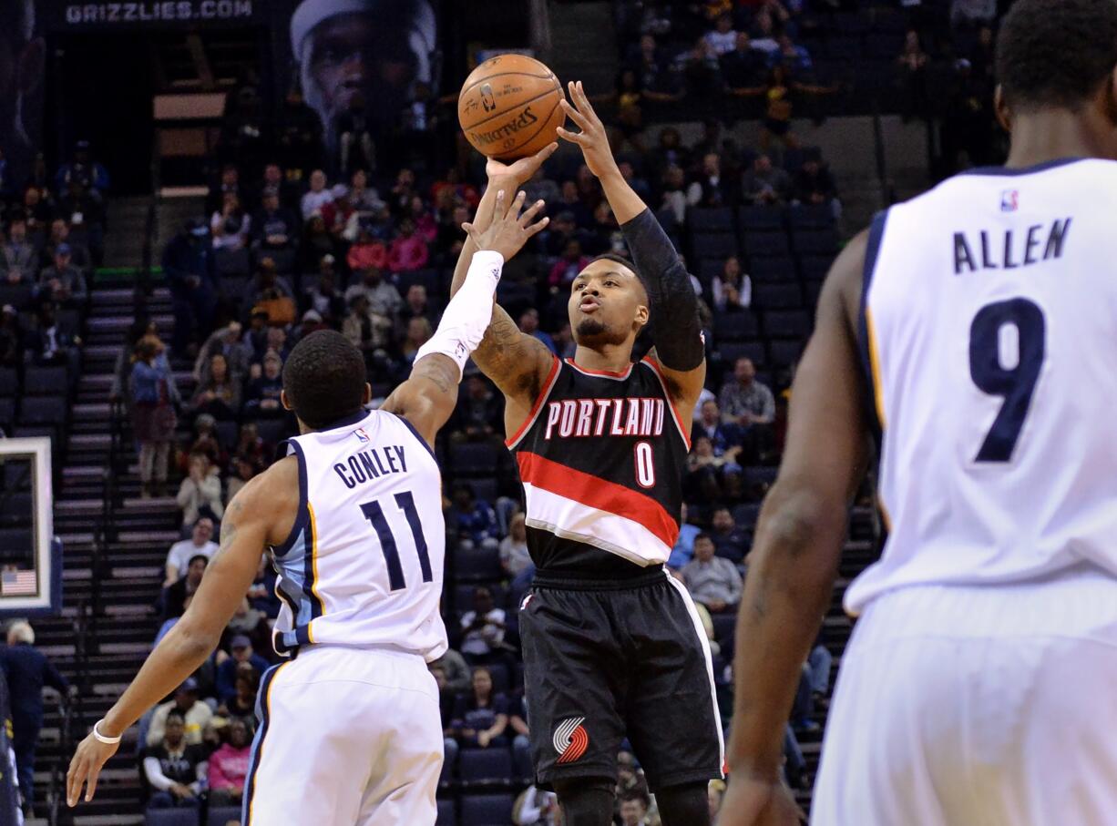 Portland Trail Blazers guard Damian Lillard (0) shoots against Memphis Grizzlies guard Mike Conley (11) in the first half of an NBA basketball game Monday, Feb. 8, 2016, in Memphis, Tenn.