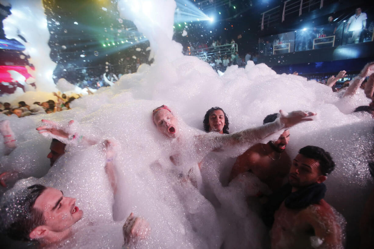 Partygoers dance in foam at The City nightclub in Cancun, Mexico. Data so far this year is mixed on whether concerns about Zika are affecting spring break bookings for hotel stays and air travel to affected zones.