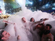 Partygoers dance in foam at The City nightclub in Cancun, Mexico. Data so far this year is mixed on whether concerns about Zika are affecting spring break bookings for hotel stays and air travel to affected zones.