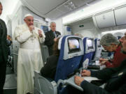 Pope Francis meets journalists aboard the plane during the flight from Ciudad Juarez, Mexico to Rome, Italy, on Thur sday.