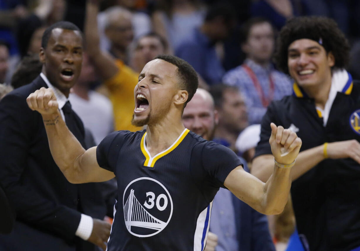 Golden State Warriors guard Stephen Curry (30) celebrates after hitting the game-winning shot in overtime of an NBA basketball game against the Oklahoma City Thunder in Oklahoma City, Saturday, Feb. 27, 2016. Golden State won 121-118.