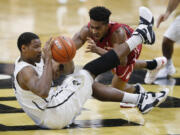 Colorado forward Tory Miller, left, passes the ball after picking it up in a scramble with Washington State guard Ny Redding early in the second half of an NCAA college basketball game Thursday, Feb. 11, 2016, in Boulder, Colo.