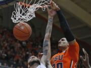 Oregon State's Gary Payton II, right, dunks over Washington State's Derrien King in the first half of an NCAA college basketball game in Corvallis, Ore., on Sunday, Feb. 28, 2016. (AP Photo/Timothy J.