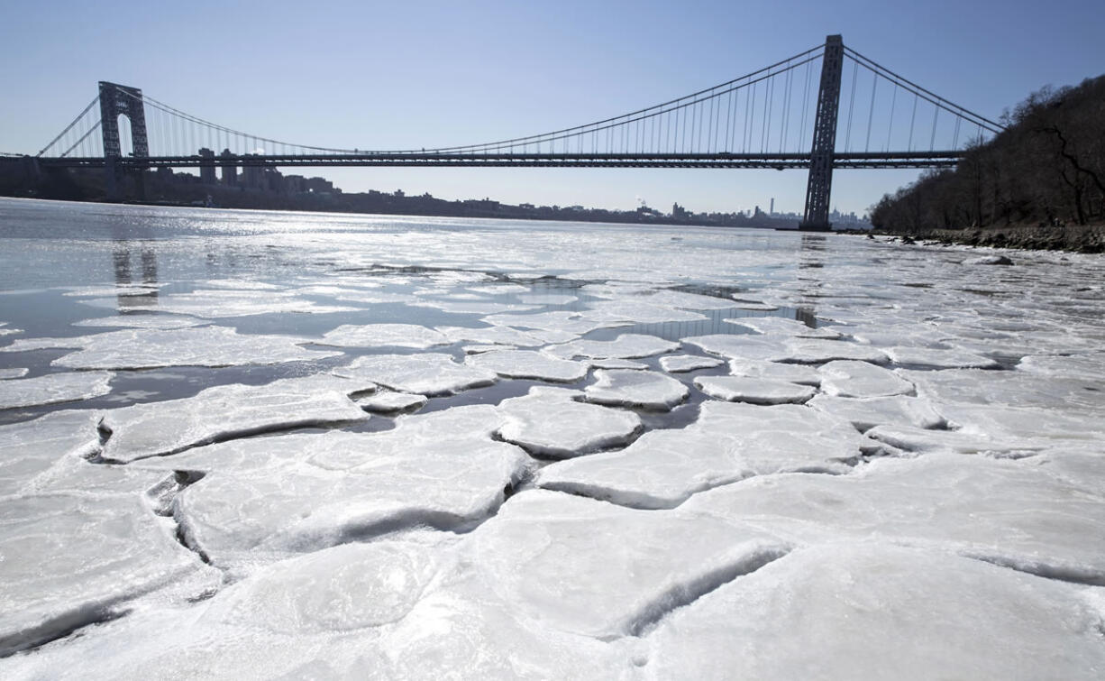 Ice begins to form on the banks of the Hudson River on Sunday in Englewood Cliffs, N.J., as temperatures dove to the single digits this weekend.