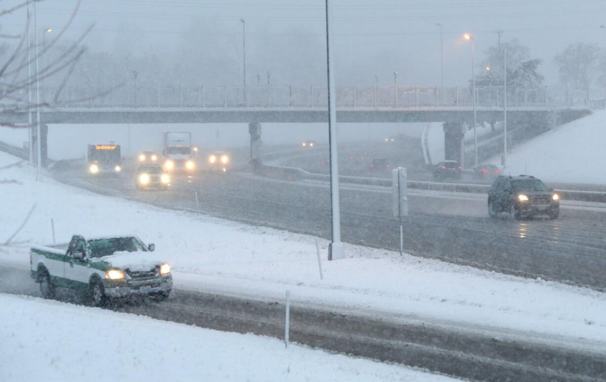 Traffic on Interstate 44 rolls by the Arsenal Street overpass as snow continues to cover the St. Louis, Mo., area on Wednesday. (Cristina Fletes /St.