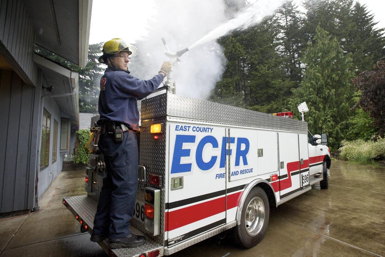 Volunteer firefighter Frank Billington goes through a routine check on the county mini pumper in 2015 at Station 96 in Bear Prairie, where he lived with his family for the last seven years before the district&#039;s board voted to sell the property at a meeting in January.