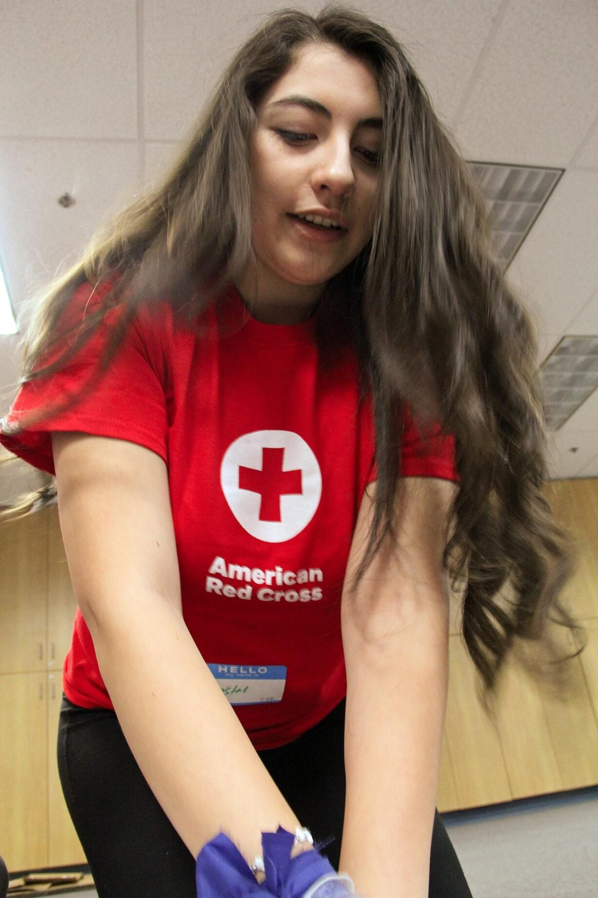 Skyview High School senior Crystal Navarro practices chest compressions during CPR instruction.