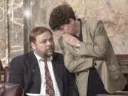 Sen. Don Benton, R-Vancouver, left, and Sen. Pam Roach, R-Sumner, talk in 2000 on the Senate floor in Olympia.