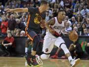Portland’s Damian Lillard (0) got the better of Golden State’s Stephen Curry, left, during their last meeting on Feb. 19 with a 51-point effort and a win.