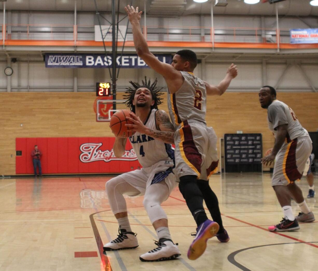 Clark College&#039;s Glenn Baral, left, attempts a shot against Yakima Valley in the Northwest Athletic Conference tournament quarterfinals Friday at Everett Community College. Clark won 65-57.