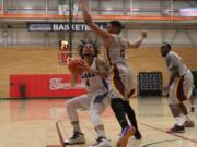 Clark College&#039;s Glenn Baral, left, attempts a shot against Yakima Valley in the Northwest Athletic Conference tournament quarterfinals Friday at Everett Community College. Clark won 65-57.