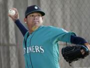 Seattle Mariners starting pitcher Felix Hernandez throws during spring training baseball practice Saturday, Feb. 27, 2016, in Peoria, Ariz.