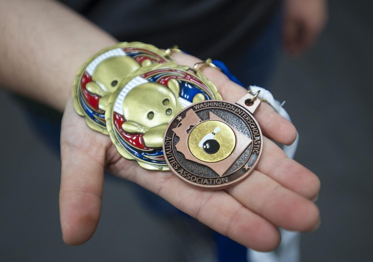 All-region bowler of the year Shannon Bliquez shows her medals in Vancouver, Thursday March 10, 2016.