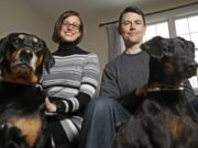 Julie Sanders, left, and her husband Cory Donovan, seen with their dogs, Raven, left, and Lula, created a new phone app, Fur Alert, that alerts subscribers if a fellow subscriber has lost a dog or cat in their area.