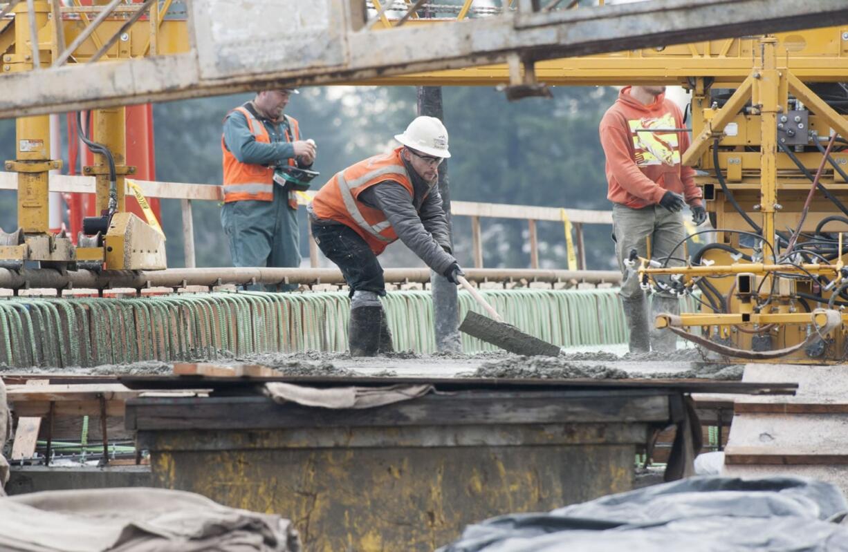 Construction workers pour concrete at the Interstate 205-N.E. 18th Street interchange project bridge deck on Jan. 7 in Vancouver. The Department of Ecology is fining project contractor Cascade Bridge for allowing runoff into Burnt Bridge Creek.