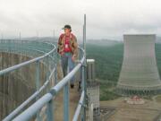 Energy Northwest employee Randy Crawford walks around the top of a cooling tower in Satsop, Wash., in 1999. The Energy Facility State Evaluation Council approved the nuclear project, though it was never completed.