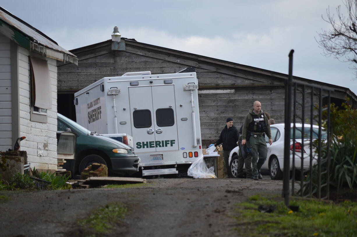 Officers conduct a search of a home in Brush Prairie Thursday afternoon. The search blocked a stretch of Northeast 119th Street temporarily as officers searched the property, and the regional bomb squad came to detonate some explosive materials.