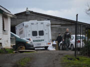 Officers conduct a search of a home in Brush Prairie Thursday afternoon. The search blocked a stretch of Northeast 119th Street temporarily as officers searched the property, and the regional bomb squad came to detonate some explosive materials.