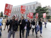 Students and other supporters protest, Wednesday, April 1, 2015, on the University of Washington campus in Seattle, in support of raising the minimum wage for campus workers to $15 an hour.