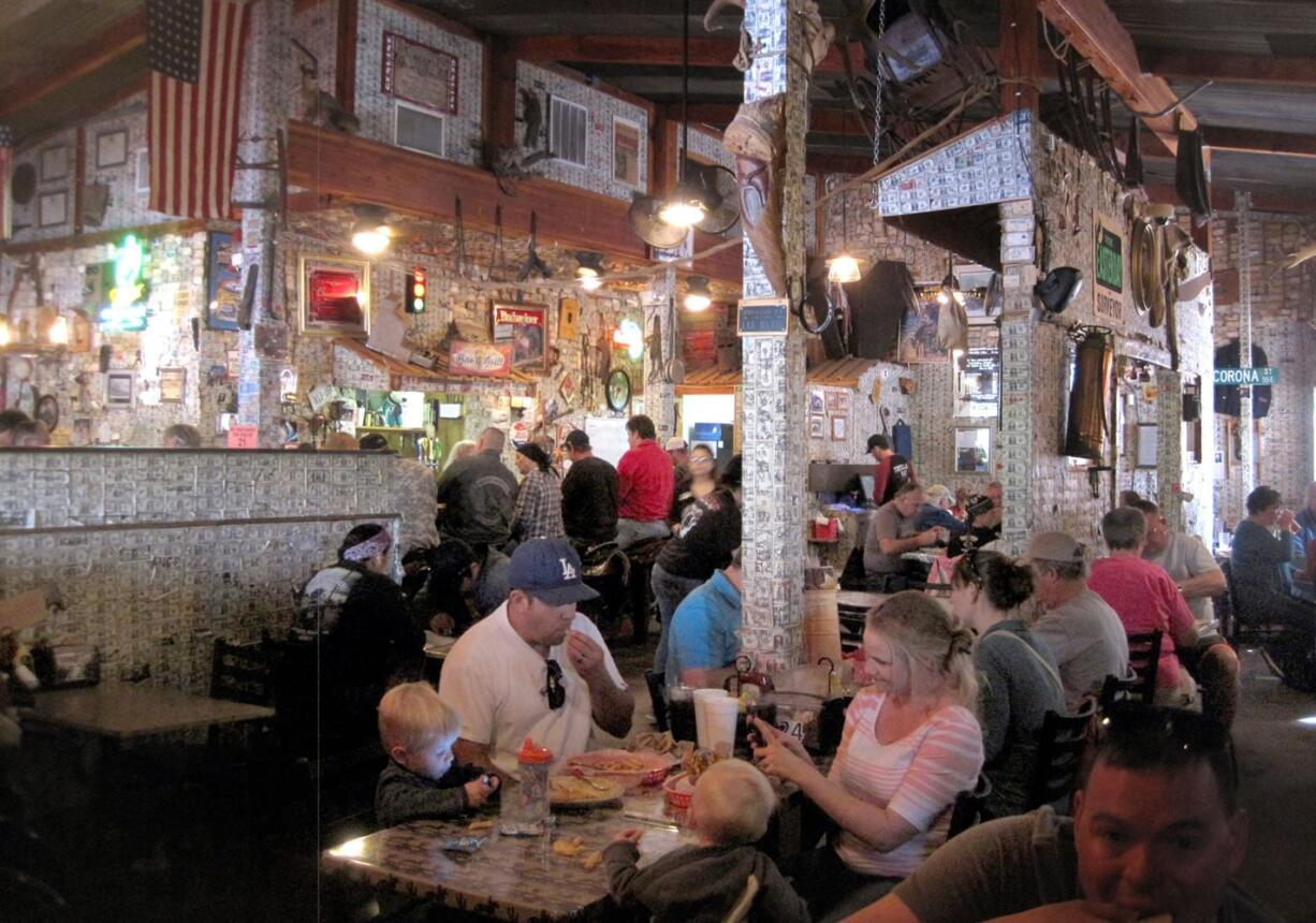 Walls are plastered with dollar bills at the Superstition Restaurant and Saloon in Tortilla Flat, Ariz.